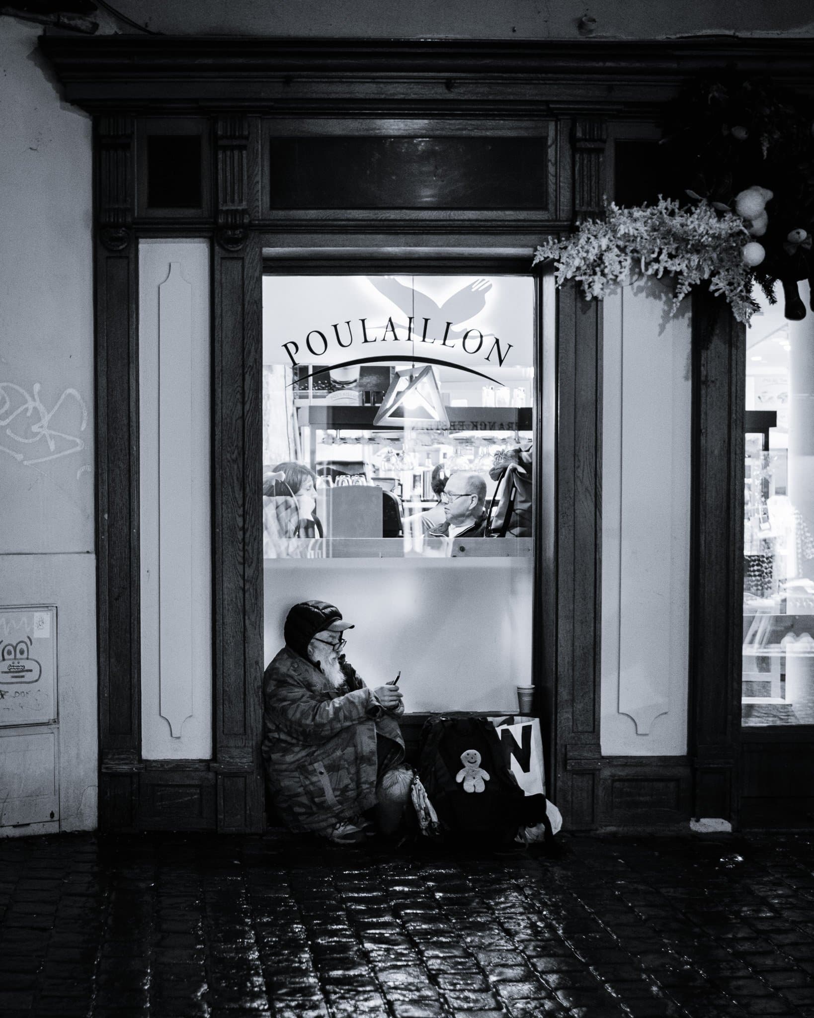 Separated by glass, united by proximity; a stitched smile defying the cold.